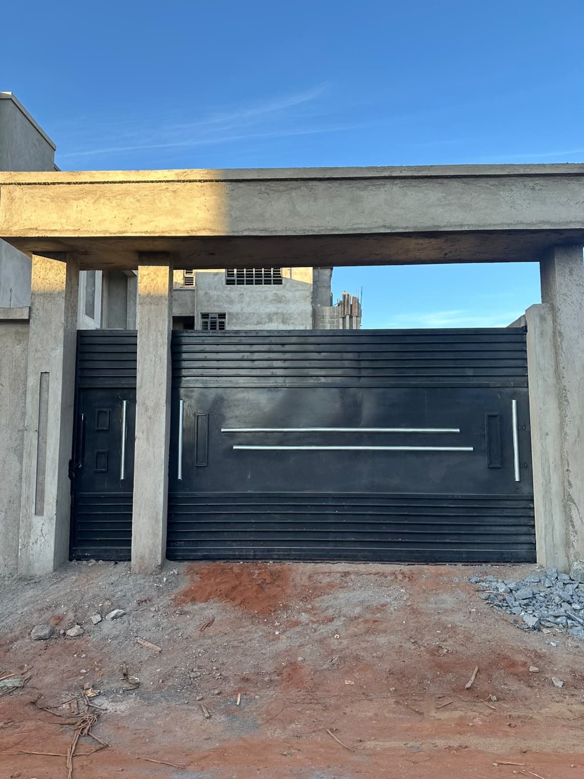 Modern slatted black steel gate installed at a building in Nairobi